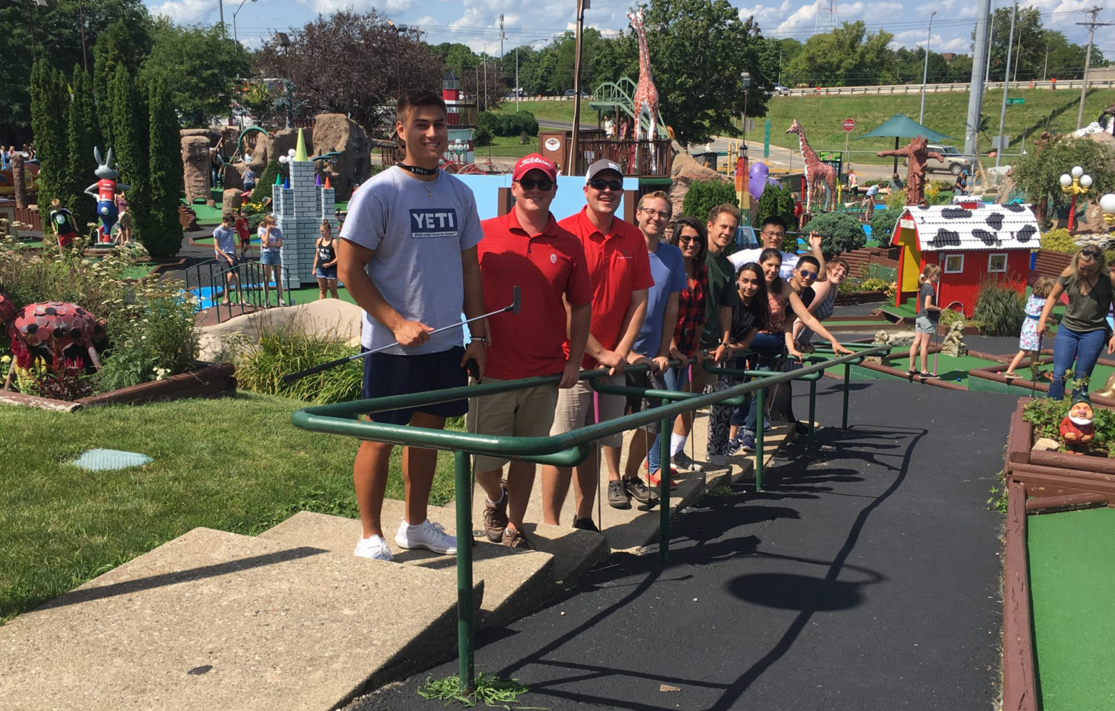 Koch Lab staff lined up at a miniature golf course.